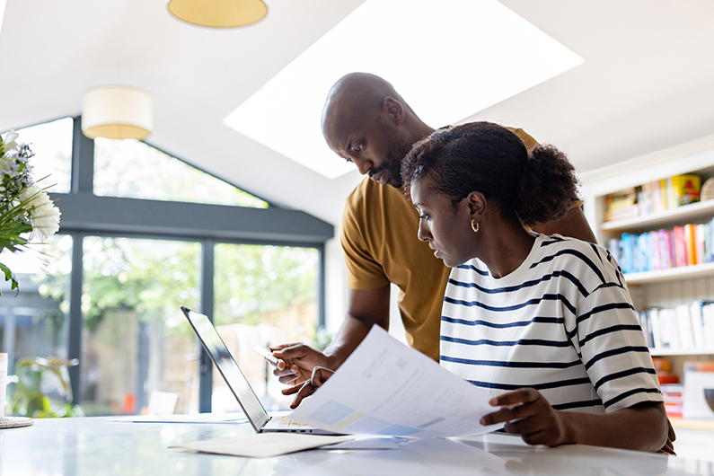 Couple reviewing finances together at home.