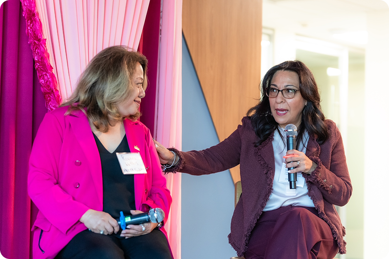 Two women talking at a conference
